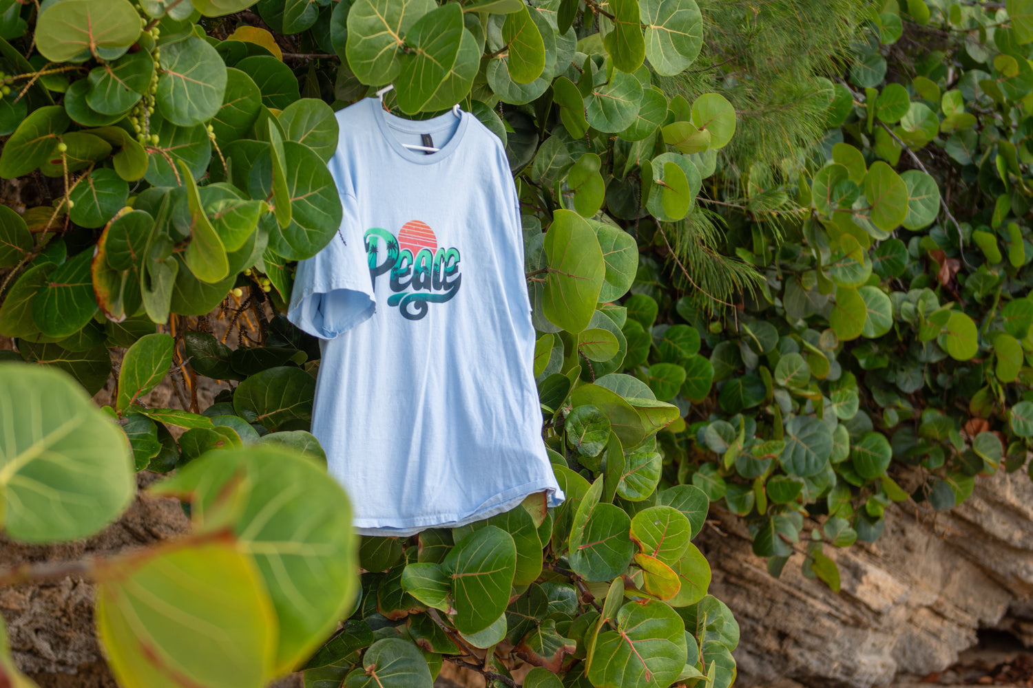 wo shirts from the Peace Collection, both featuring the word ‘Peace’ in an island-inspired print.